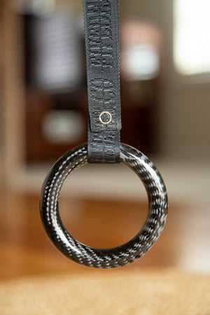 Circular carbon fibre tsurikawa with a black fivedimes woven fabric strap