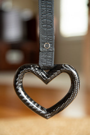 Heart shaped tsurikawa made from carbon fibre with a black fivedimes woven strap