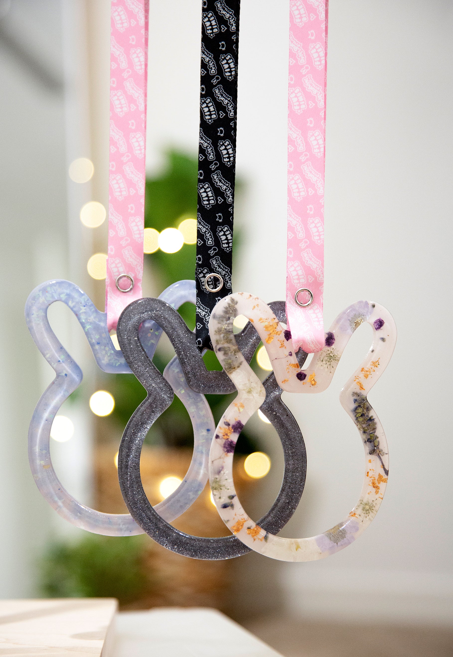 Three bunny shaped tsurikawas with black and pink straps with driftbunny and fivedimes repeated logos