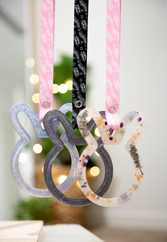 Three bunny shaped tsurikawas with black and pink straps with driftbunny and fivedimes repeated logos